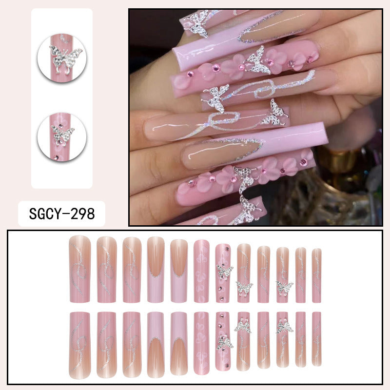 Faux ongles pailletés à porter avec des diamants en forme de fleur rose dans le nail art